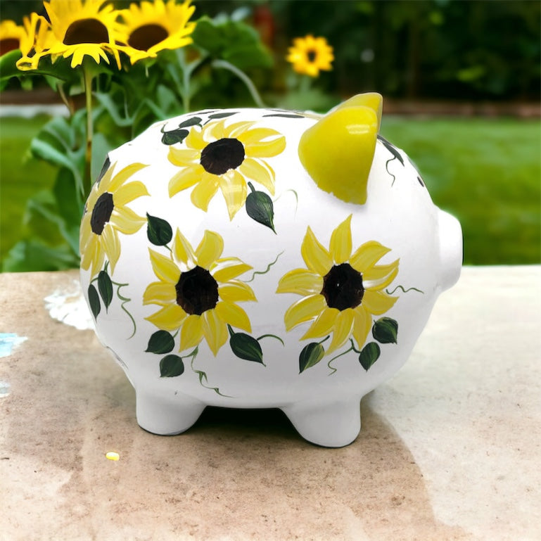Hand painted personalized piggy bank with yellow sunflowers and dark green leaves.