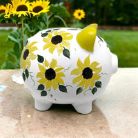 Hand painted personalized piggy bank with yellow sunflowers and dark green leaves.