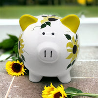Hand painted personalized piggy bank with yellow sunflowers and dark green leaves.