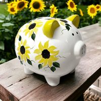 Hand painted personalized piggy bank with yellow sunflowers and dark green leaves.