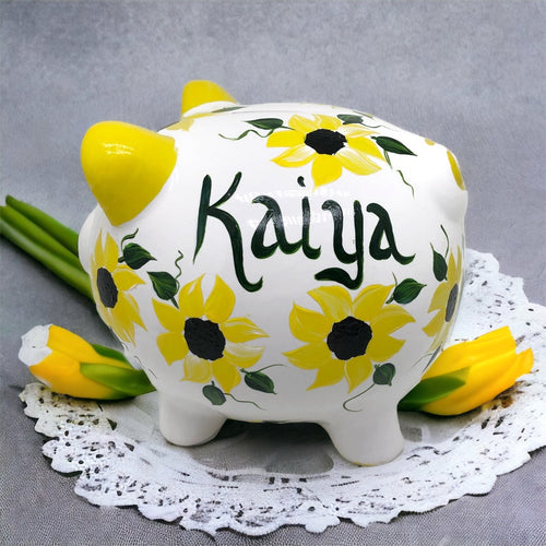 Hand painted personalized piggy bank with yellow sunflowers and dark green leaves.