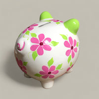 hand painted personalized piggy bank with pink daisy flowers and sage green leaves and vines. A lovely new baby gift.